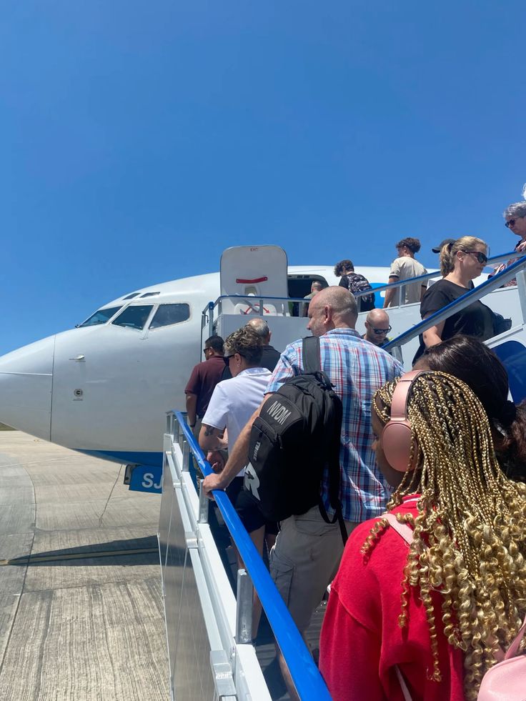 Passengers walking up stairs to board an aircraft